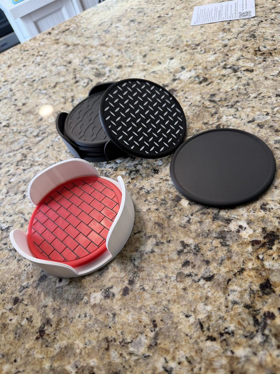 A 3D-printed coaster holder with a stack of coasters beside it