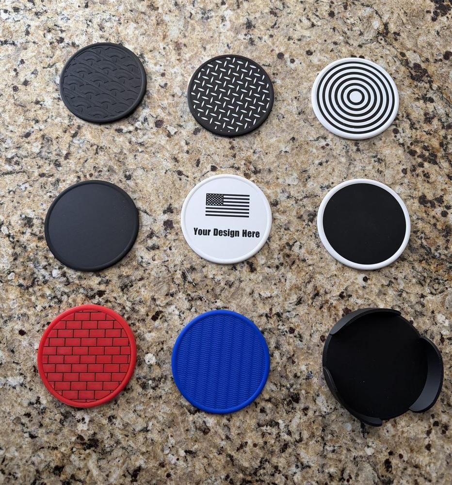 Nine 3D-printed coasters laid out in a grid, each with a different pattern