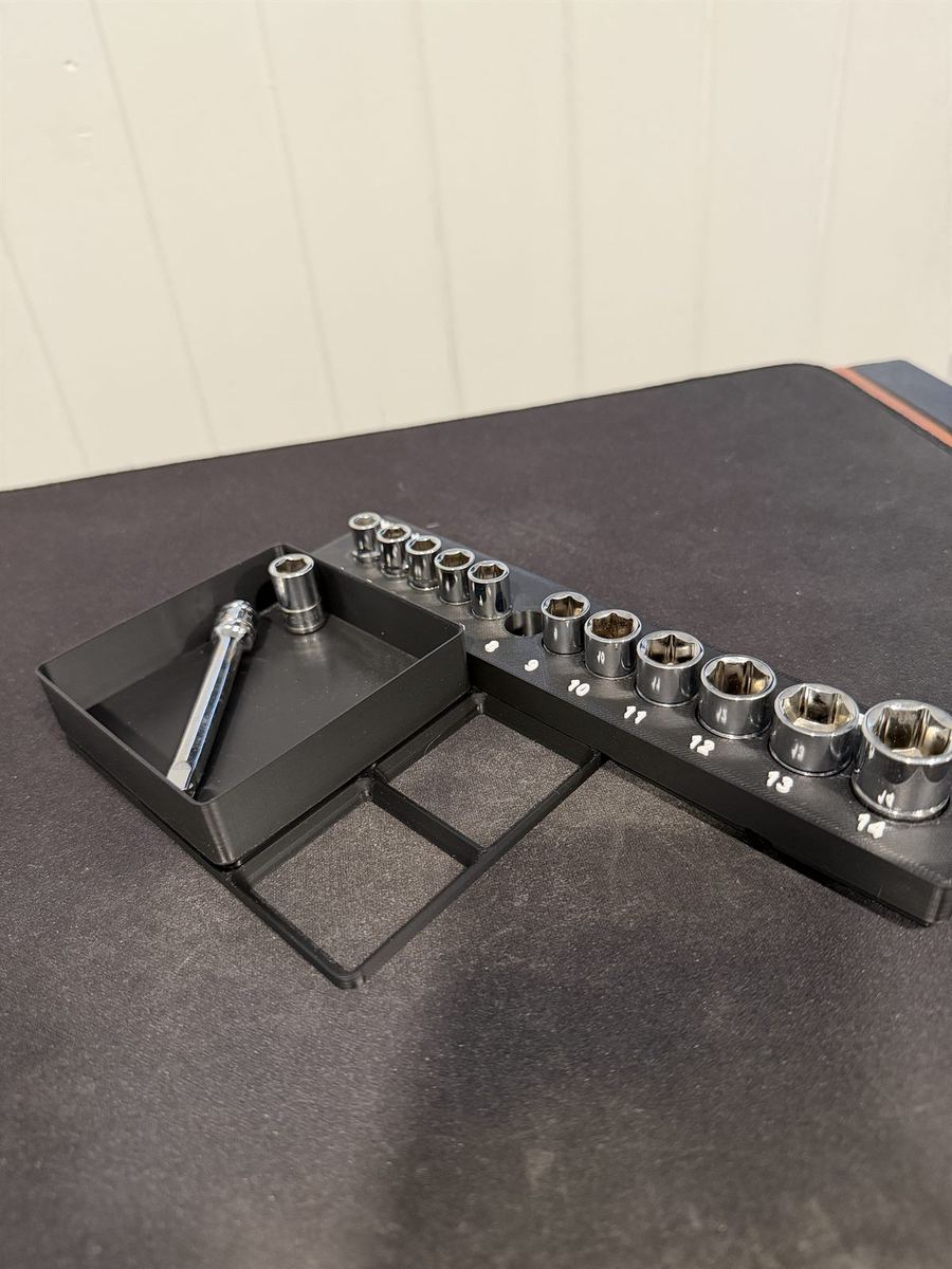 A 3D-printed socket rail with sockets labeled by size beside a small magnetic parts tray