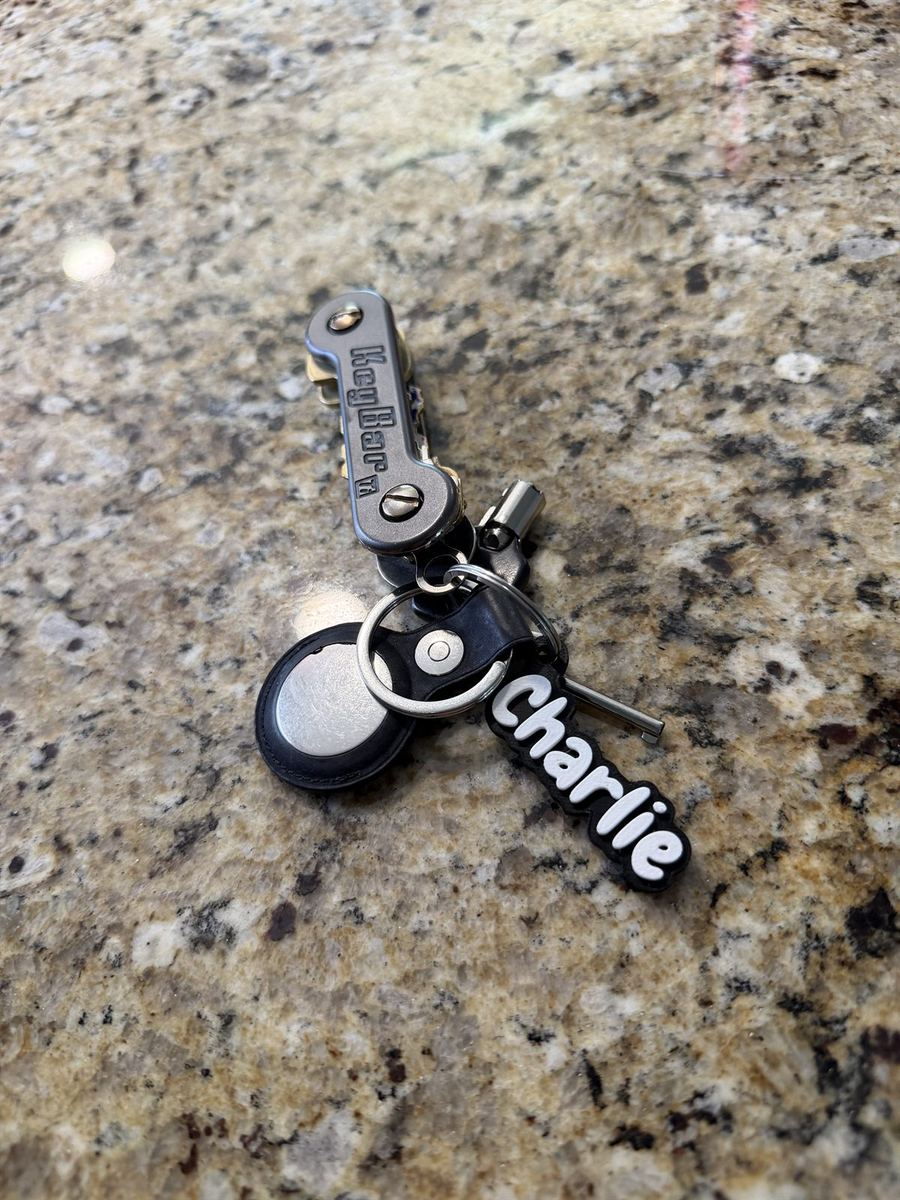 A 'Charlie' name keychain attached to a key organizer and keyring
